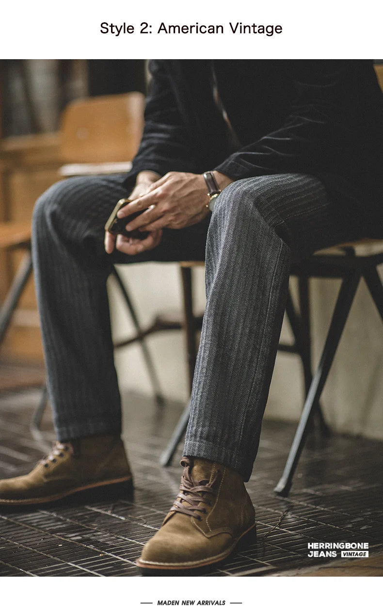 Person wearing jeans and brown shoes sitting on a chair, with 'Herringbone Jeans' branding.