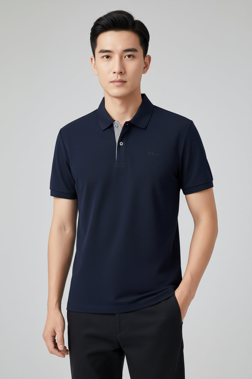 Navy blue polo shirt held by a hand with a blurred background of more shirts on hangers.