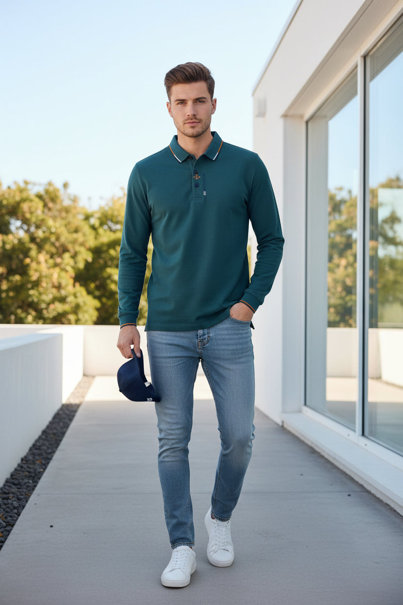 Teal polo shirt with collar and brand logo held by a hand, with blurred background