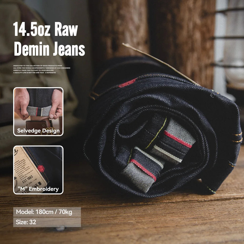 Rolled-up denim jeans with selvage design and embroidery details on a wooden surface.