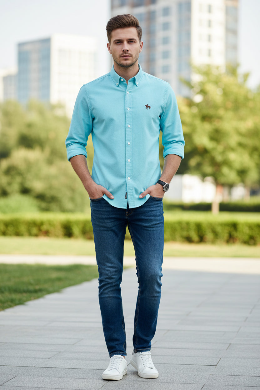 Light blue shirt with a logo on a white background