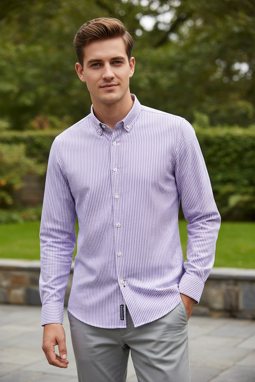 Folded purple and white striped shirt with brand label on a white background