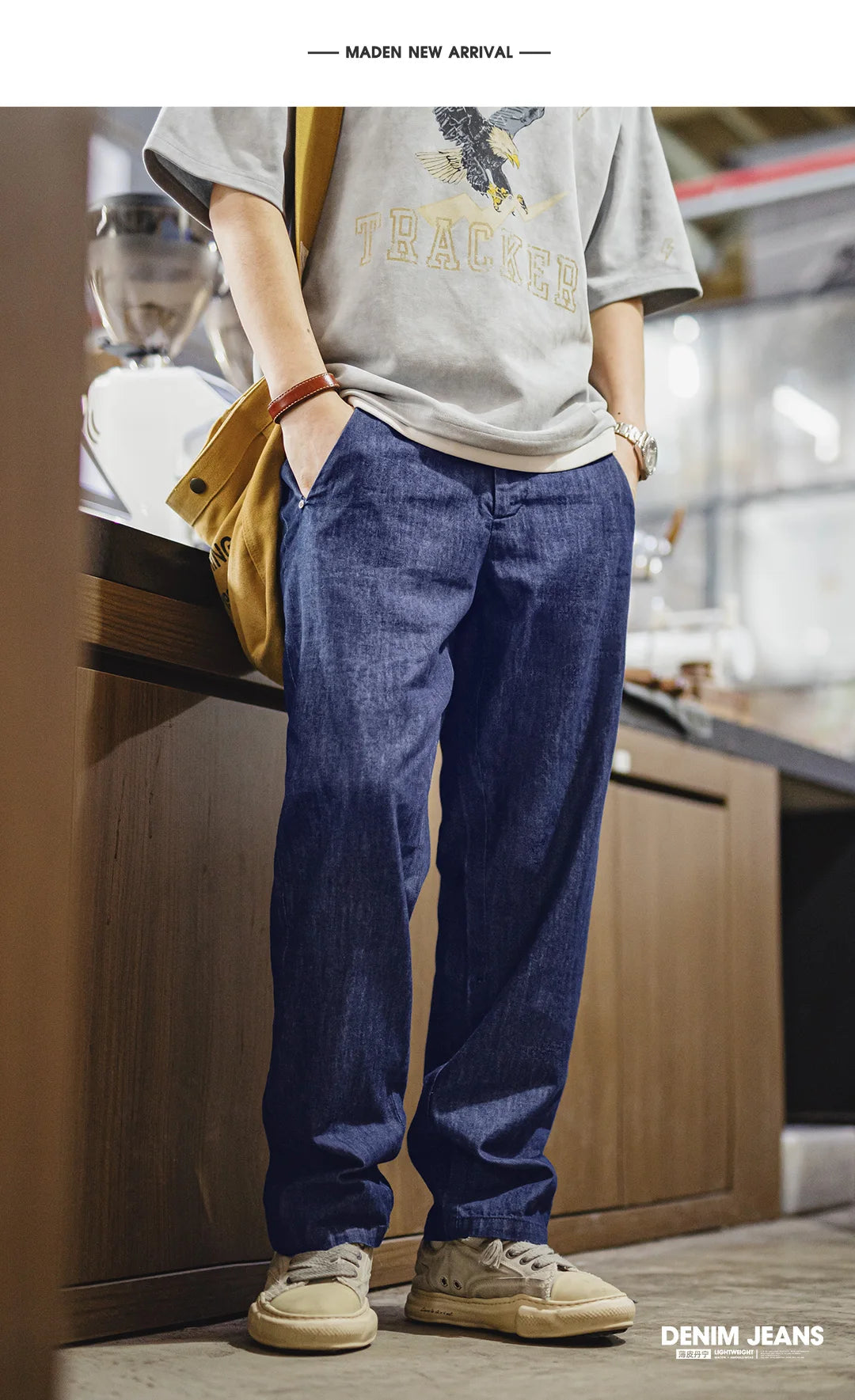 Person wearing blue denim jeans and a gray t-shirt in a kitchen setting.
