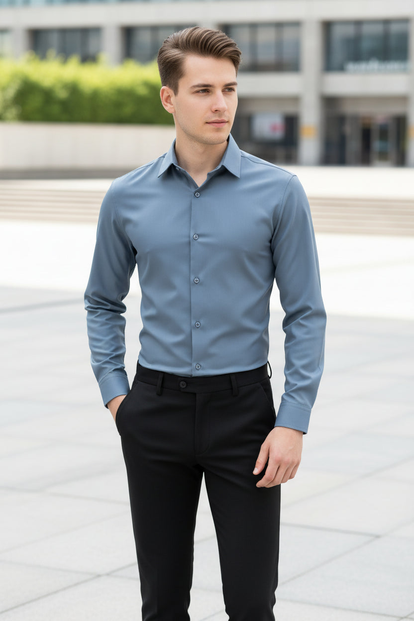 Man wearing a light blue shirt and black pants in a store setting