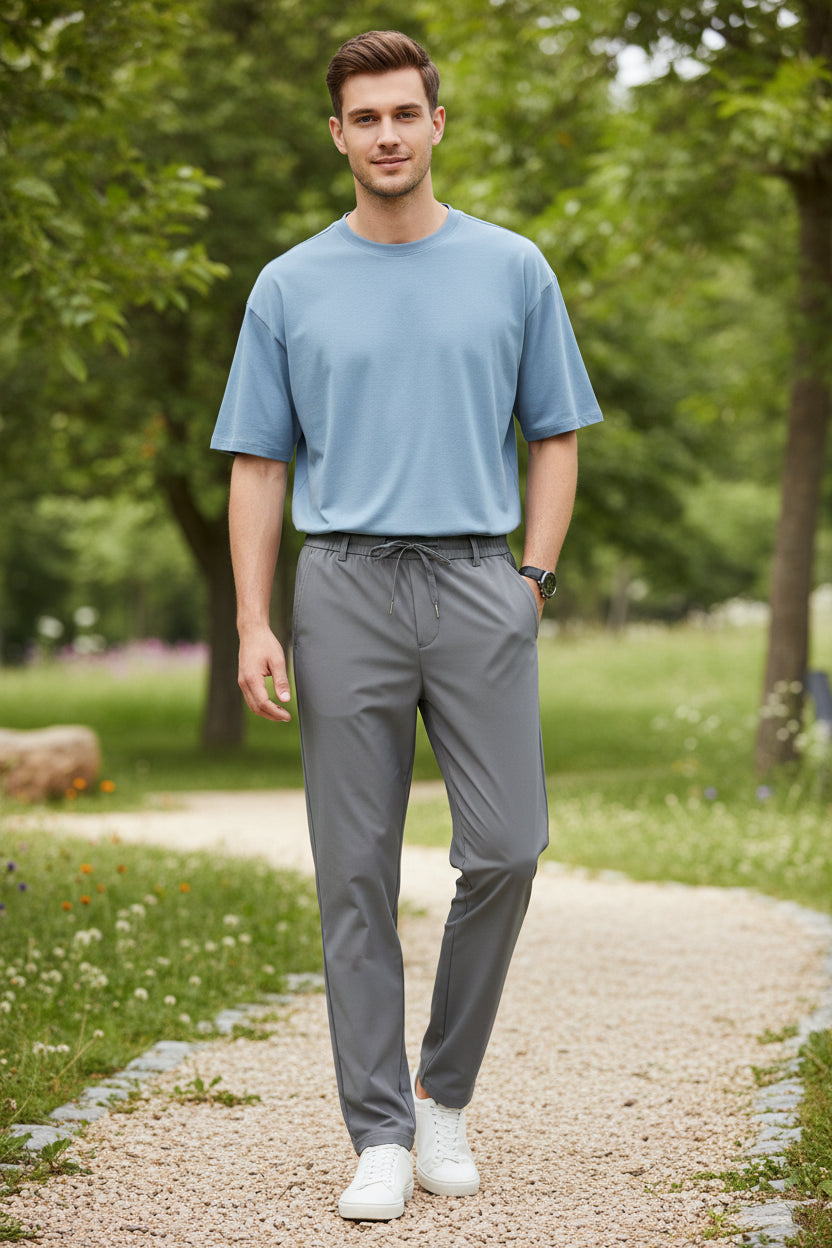 Gray pants worn by a person on a white background