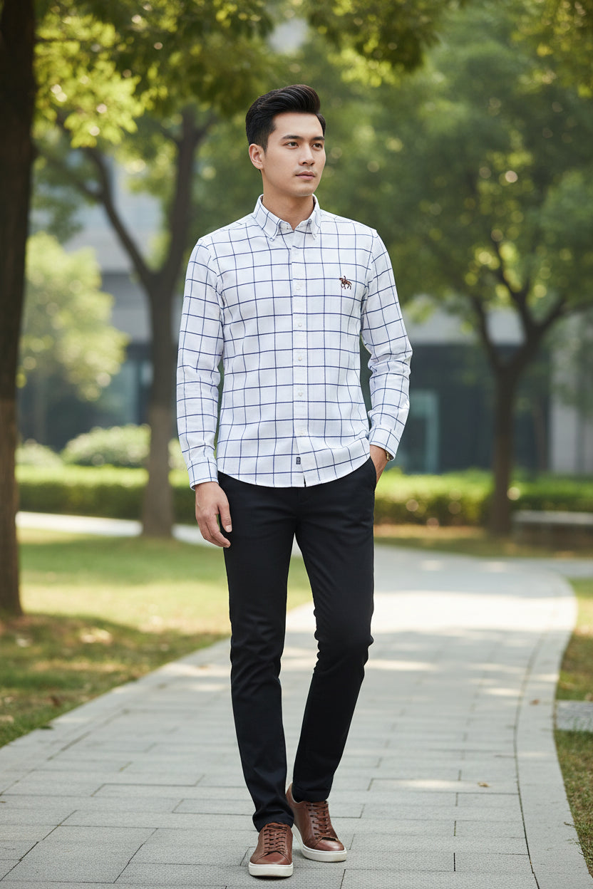 Folded white shirt with blue plaid pattern and embroidered horse logo on a light gray background