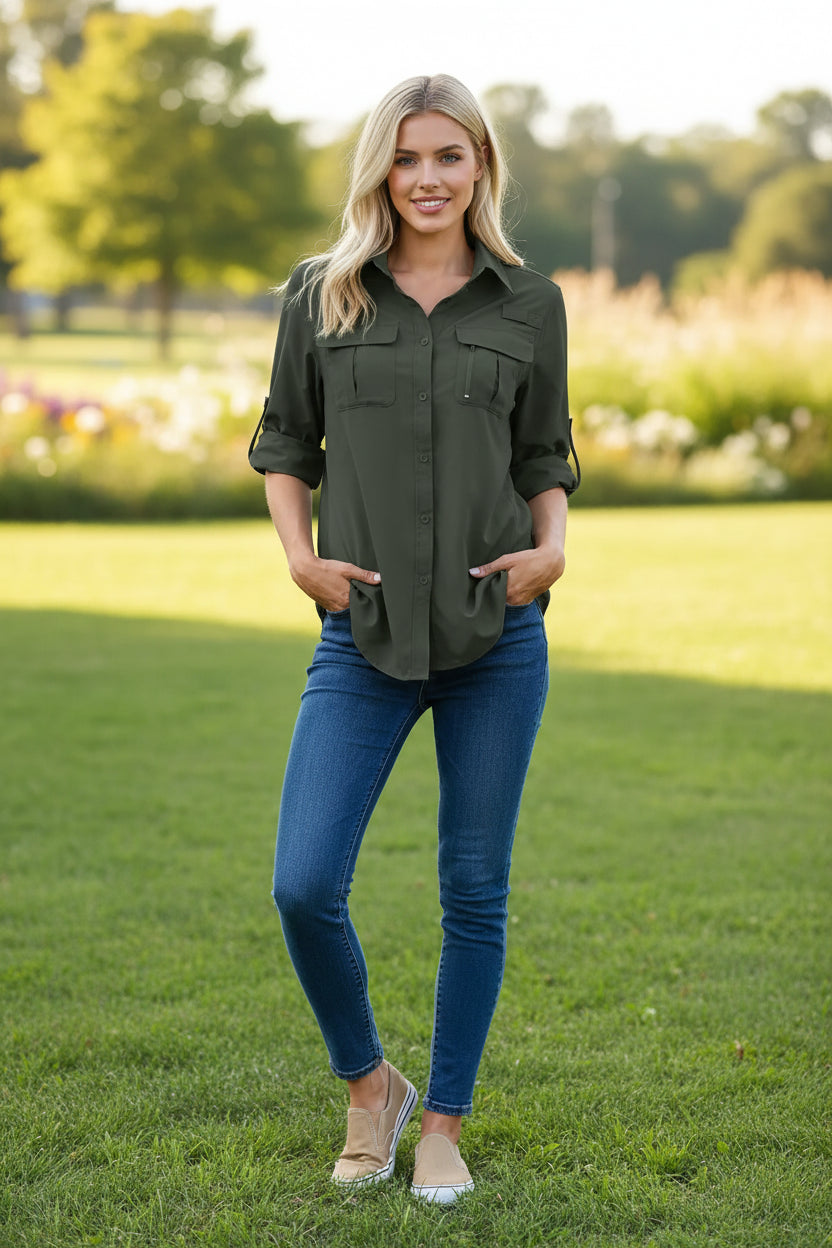 Woman wearing a dark green button-up shirt with rolled-up sleeves and blue jeans on a white background