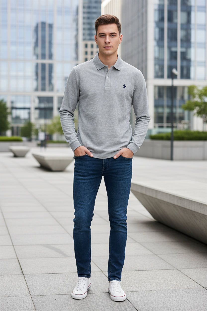 Gray polo shirt with Ralph Lauren logo held by a hand, with more shirts in the background.