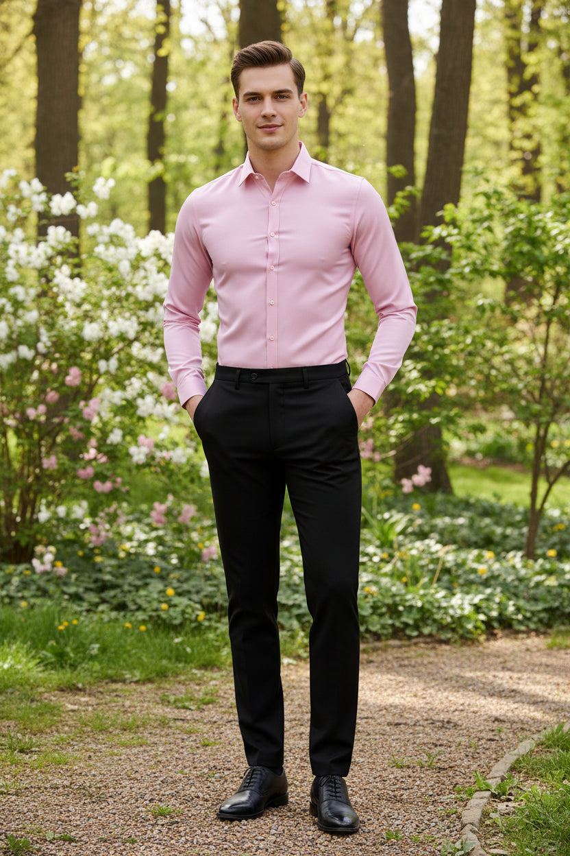 Person wearing a pink dress shirt and black pants in a clothing store.