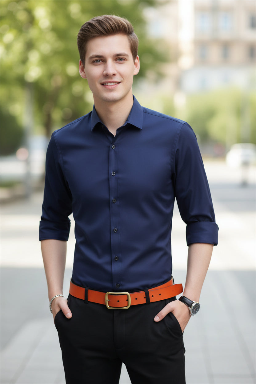 Navy blue shirt worn by a person with an orange belt on a gray background