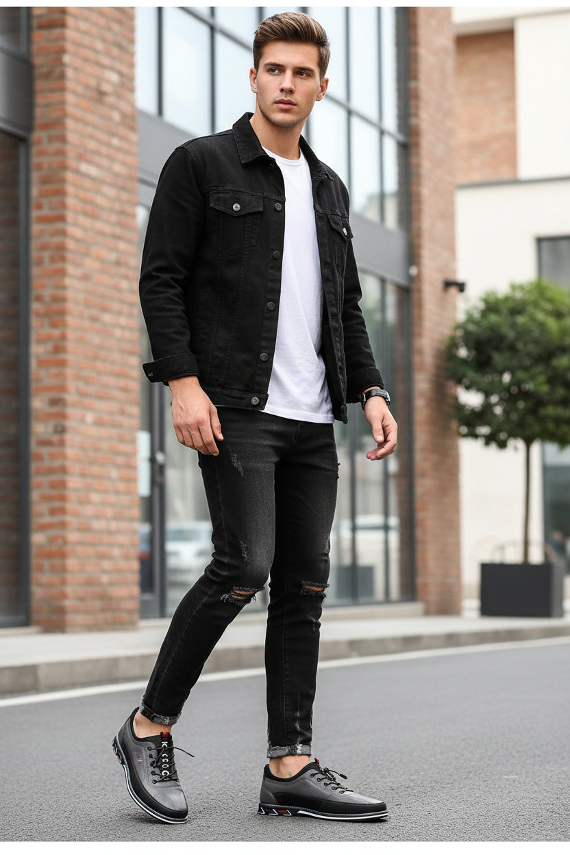 Gray and black shoes worn with ripped jeans on a gray background