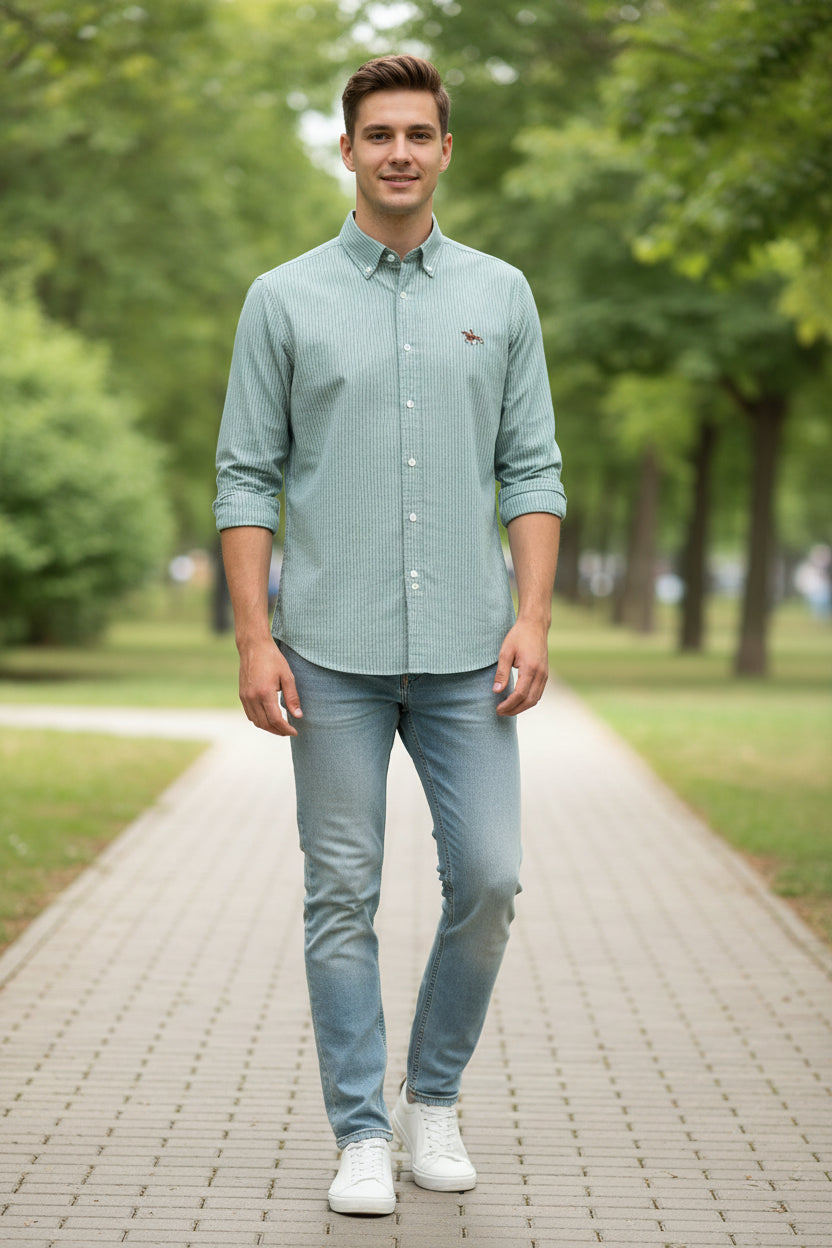 Light blue striped shirt with a logo on a white background, labeled 'Oxford Shirts'.