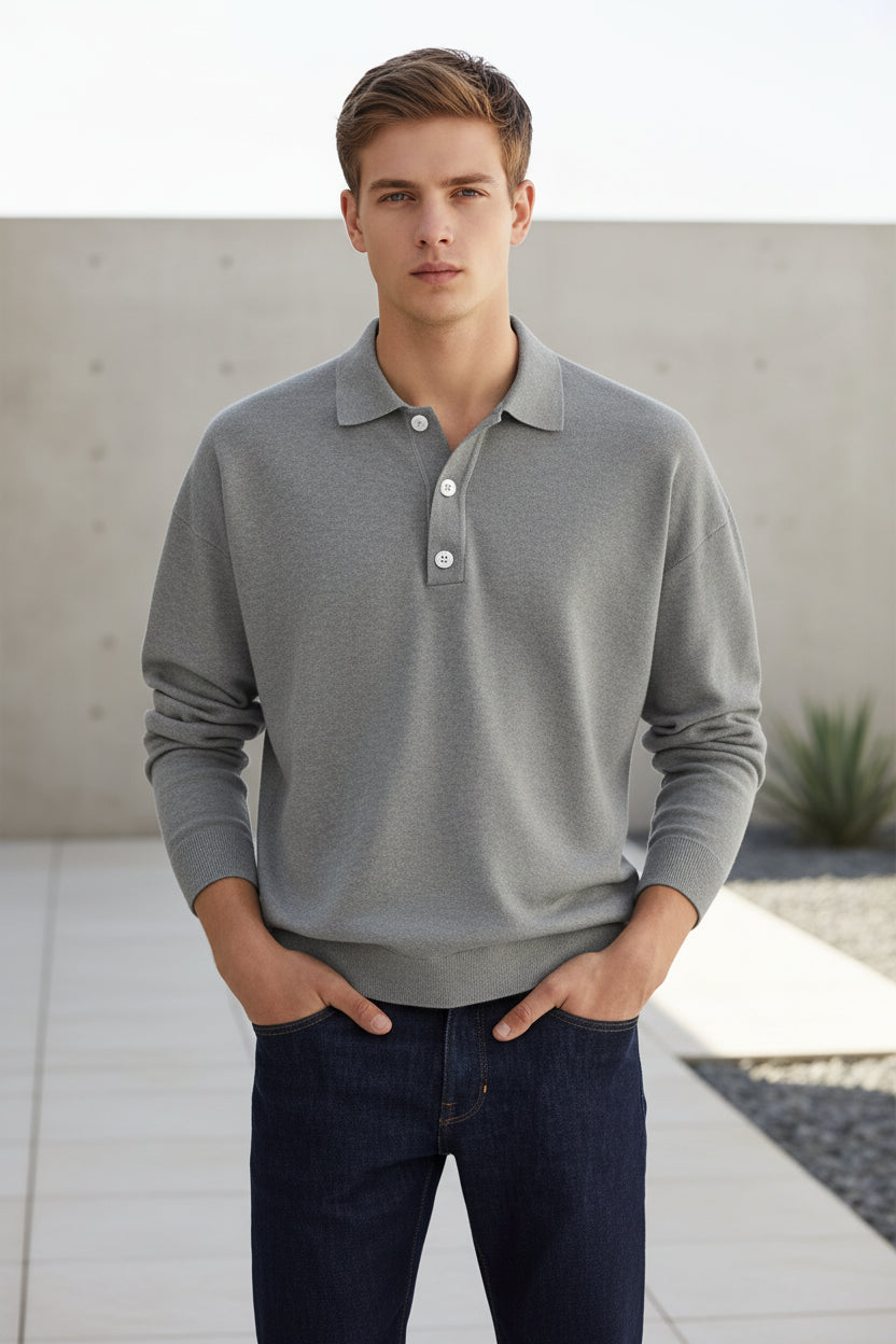 Person wearing a gray long-sleeve polo shirt against a plain background