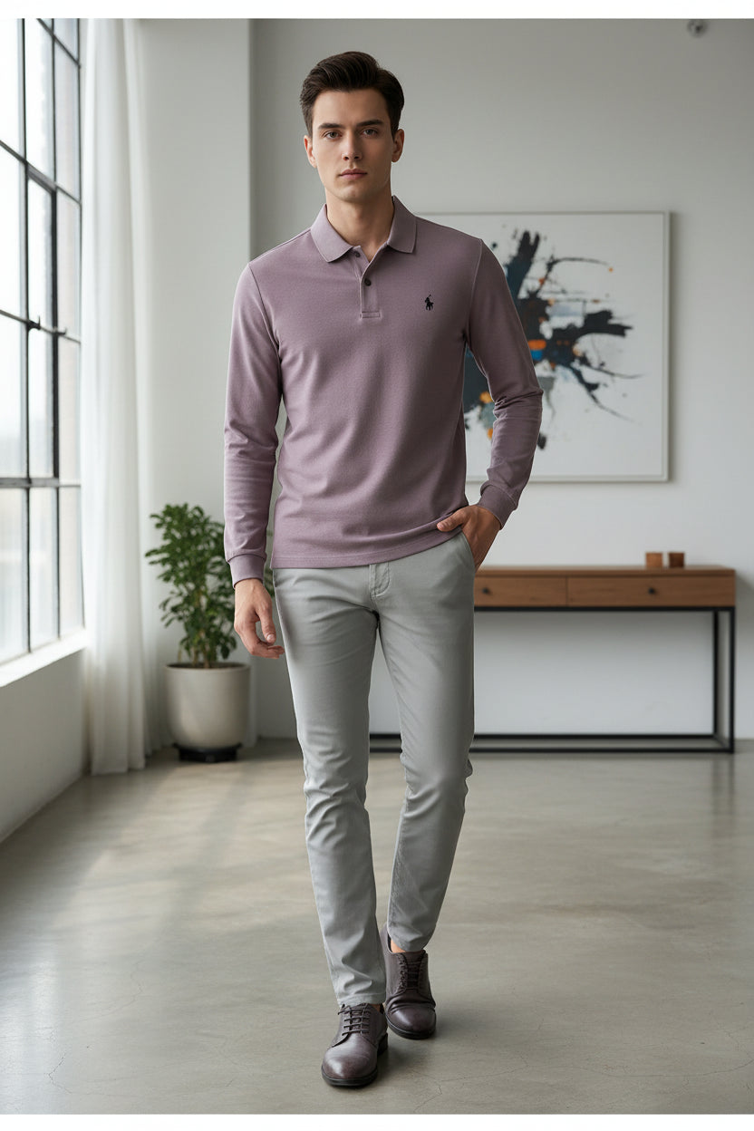 Purple polo shirt with Ralph Lauren logo held by a hand, on a blurred indoor background.