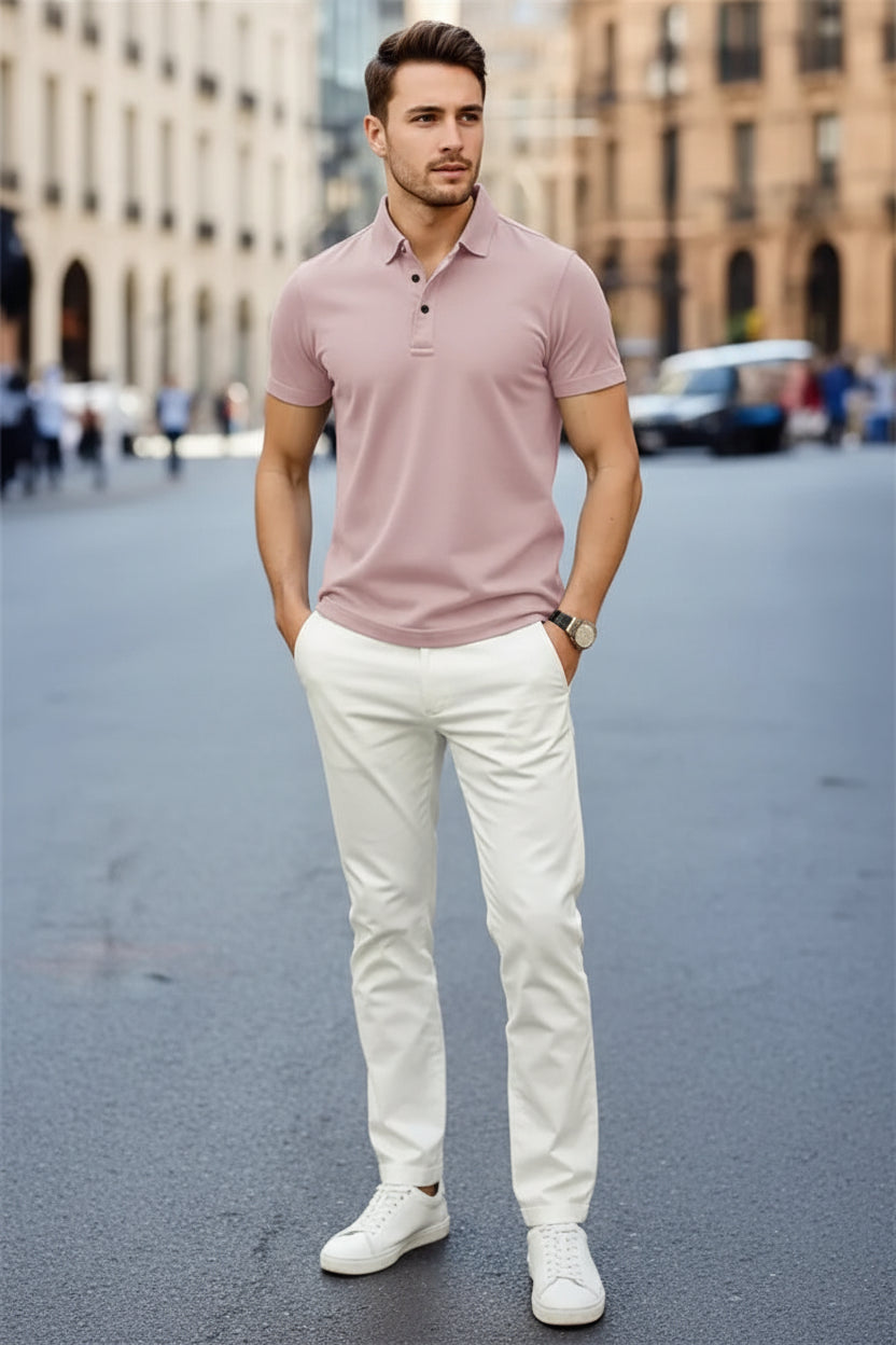 Man wearing a pink polo shirt and white pants on a city street.