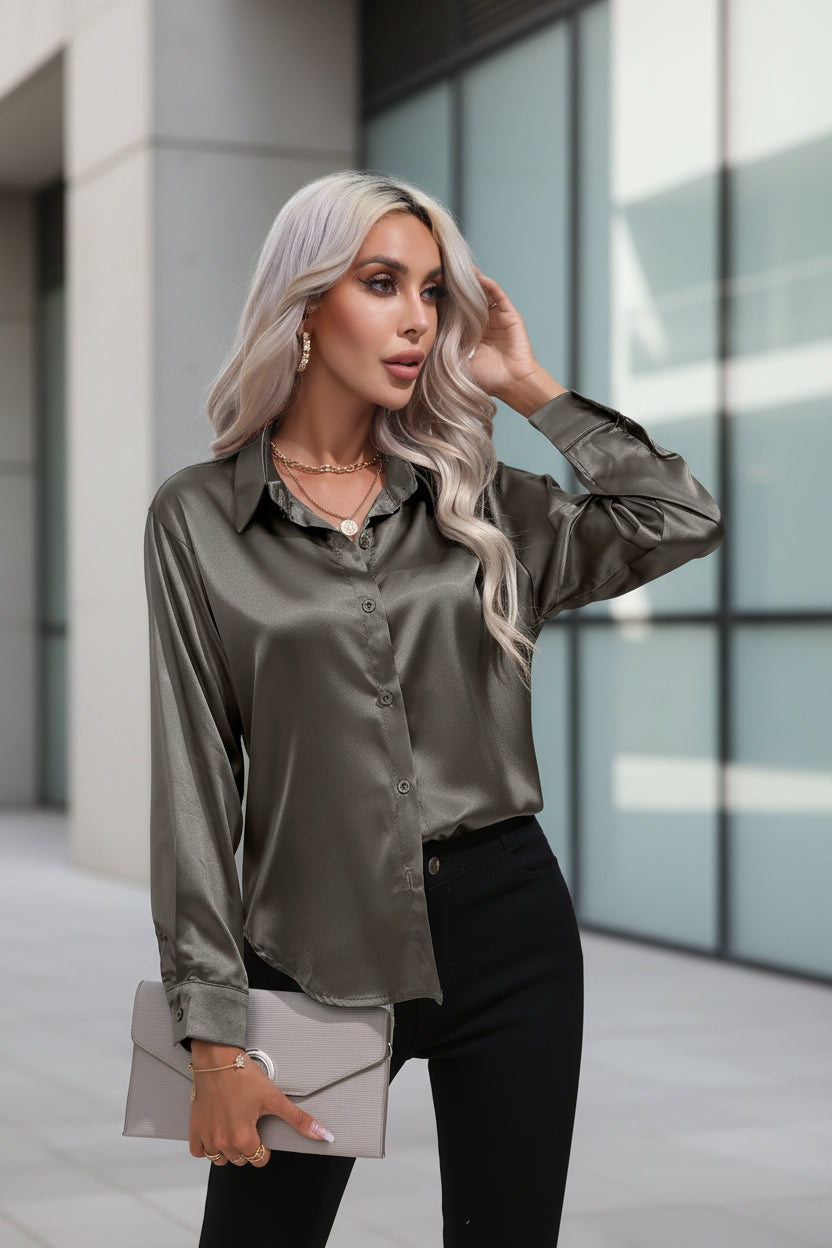 Woman wearing a satin blouse and black pants on a white background