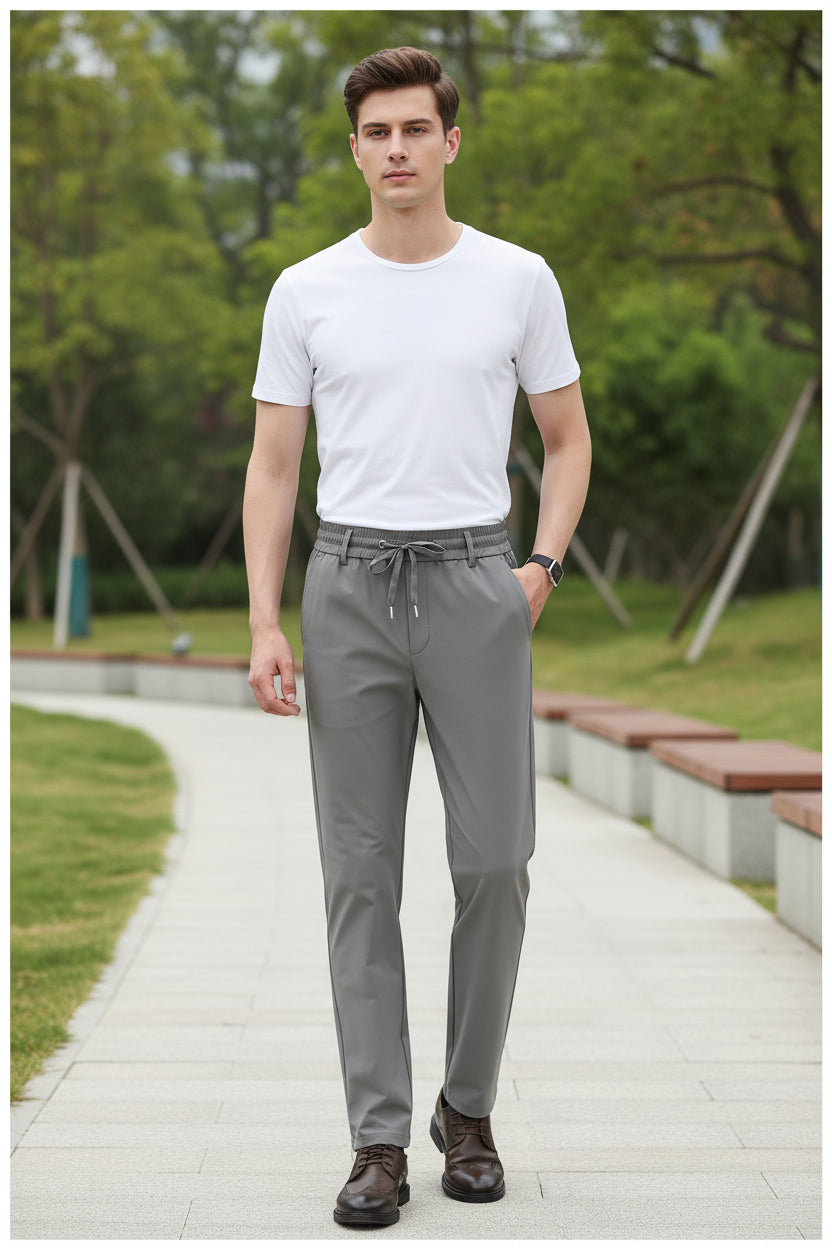 Gray pants worn by a person on a white background