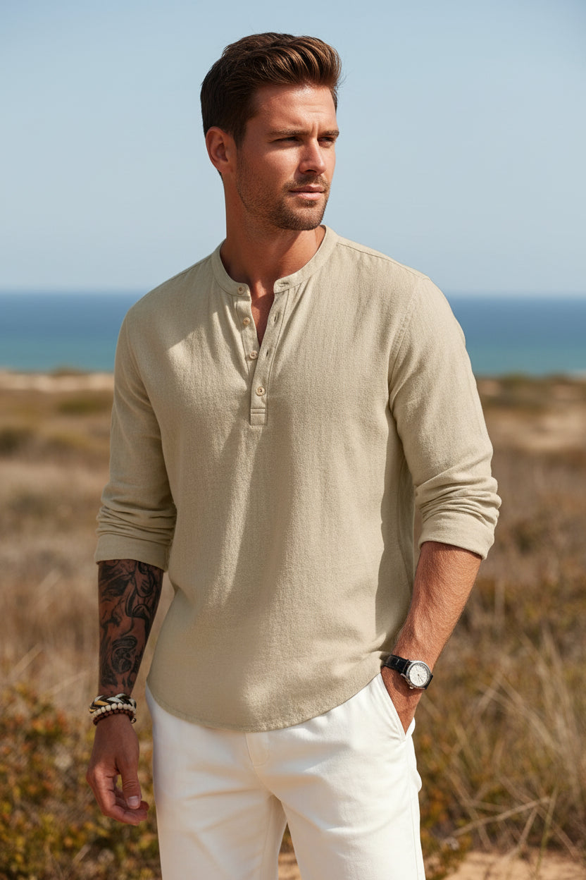 Man wearing a beige long-sleeve shirt with a logo on a white background