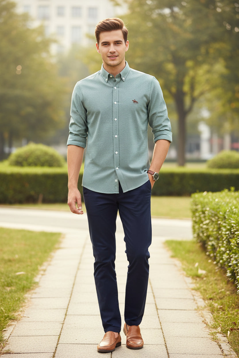 Folded green checkered shirt with a logo on a white background
