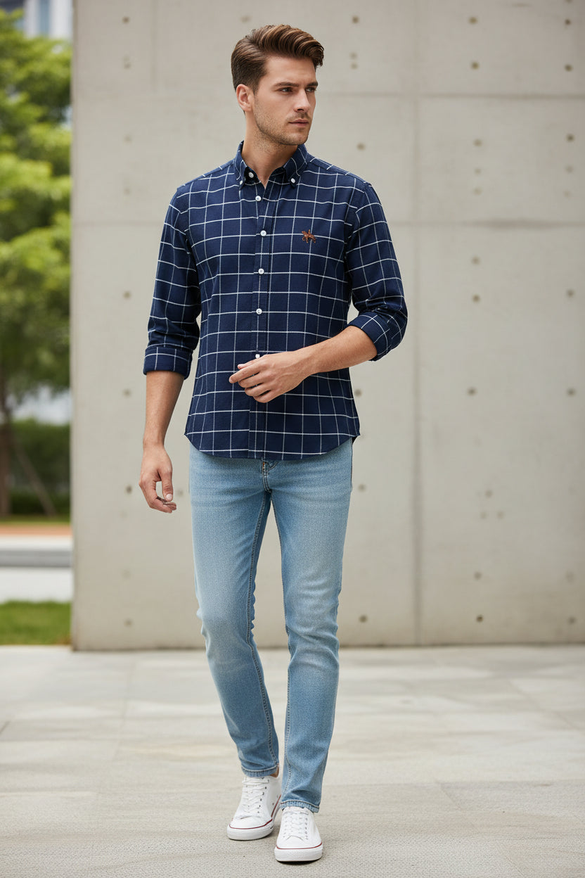 Folded navy blue checkered shirt with a brand logo on a white background