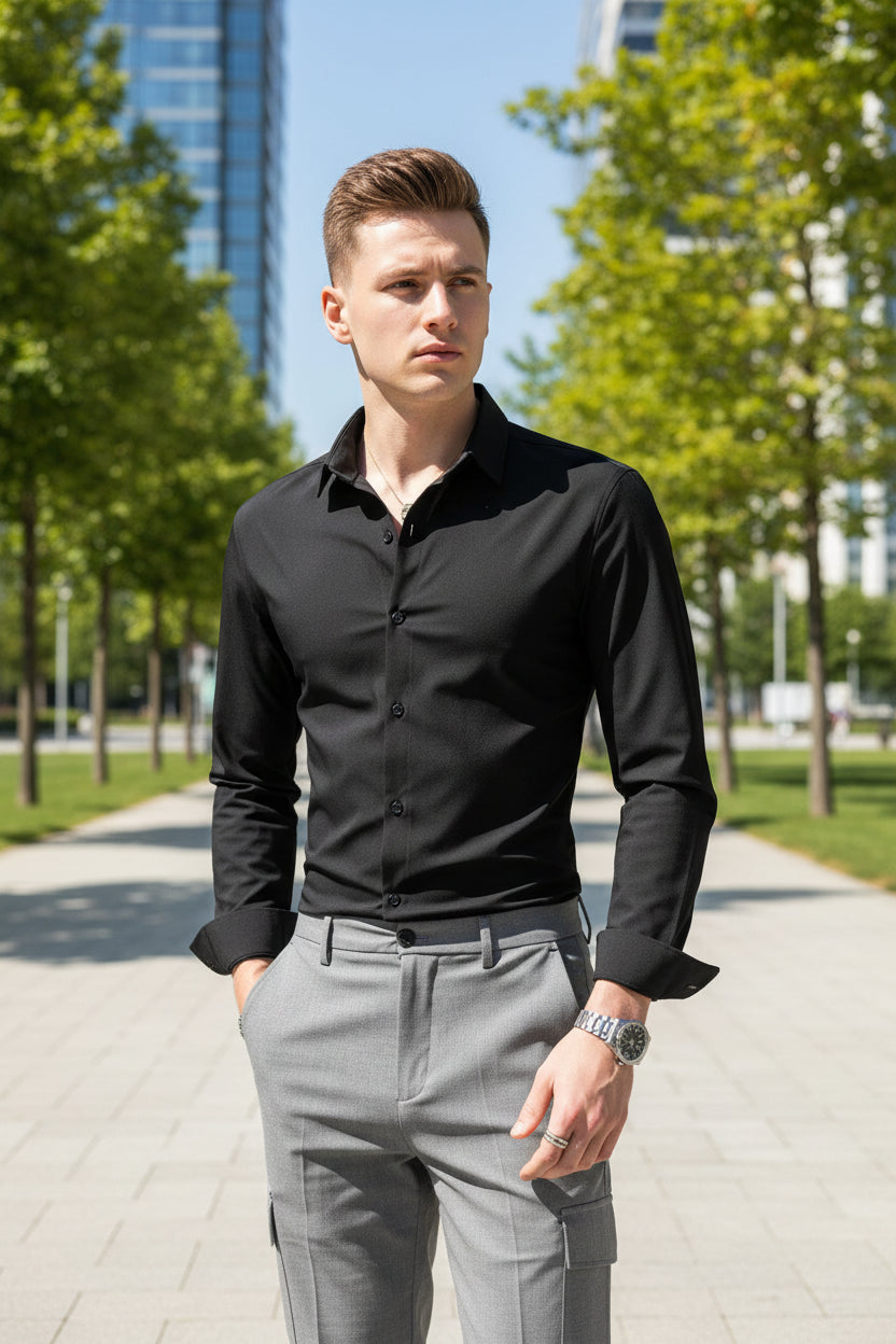 Man wearing a black dress shirt and gray pants in a clothing store setting.