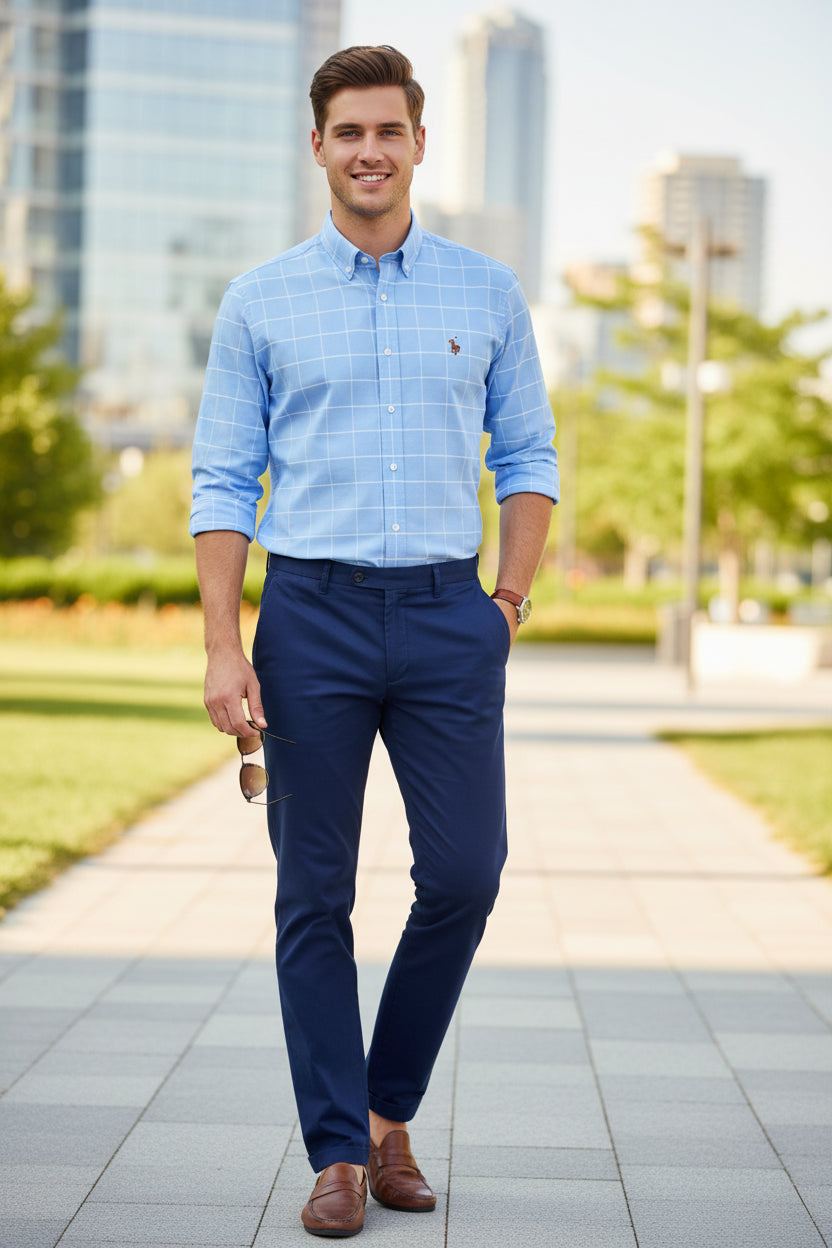 Blue checkered shirt with a small embroidered logo on a gray background