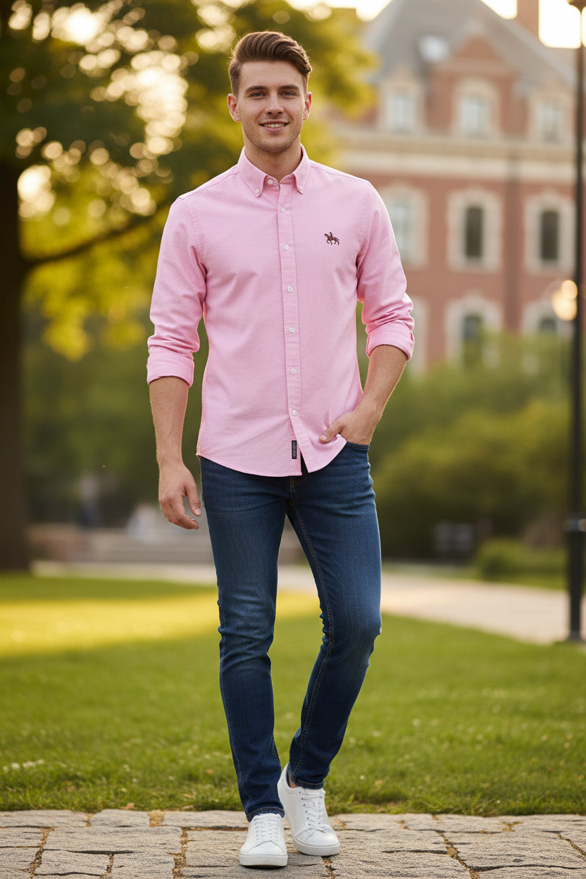 Folded pink shirt with a brand logo on a light gray background