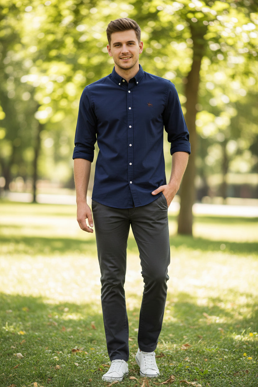 Navy blue shirt with a logo on a textured surface