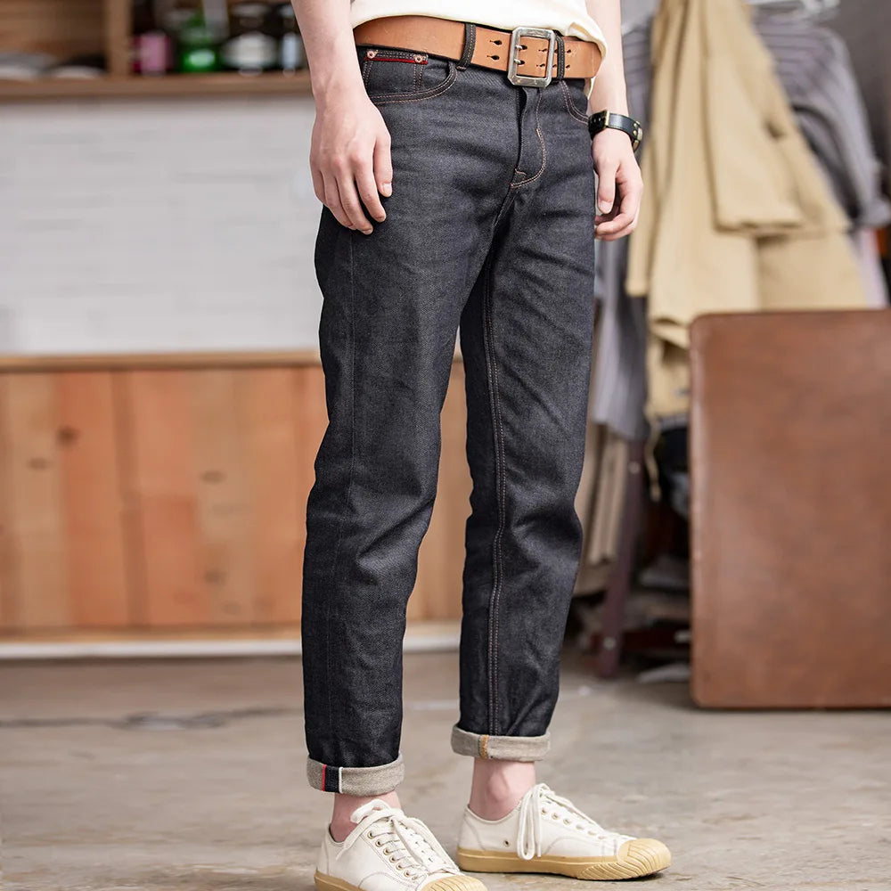 Person wearing dark jeans and white sneakers in a casual setting