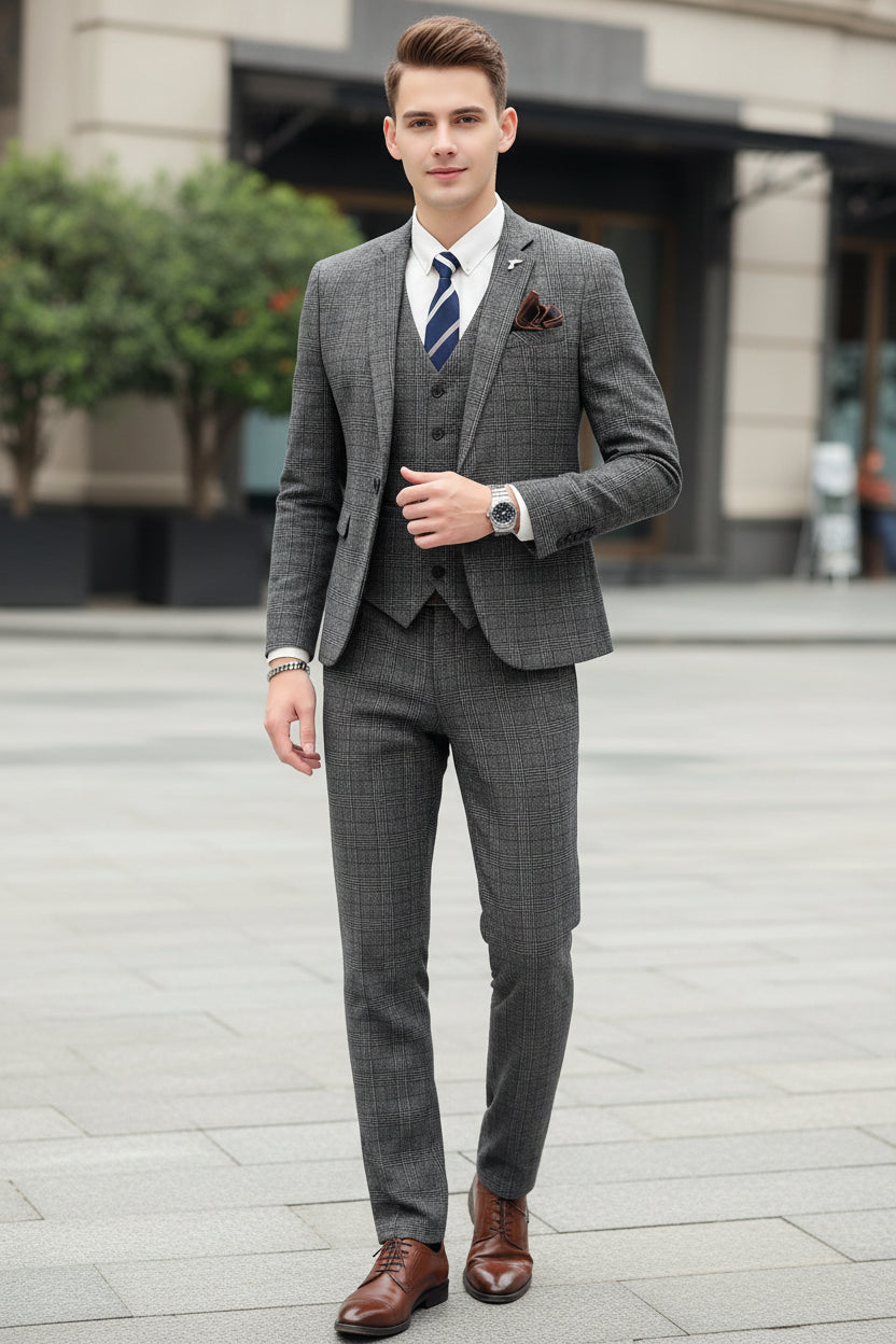 Man in a gray checkered suit holding a phone with a blurred background