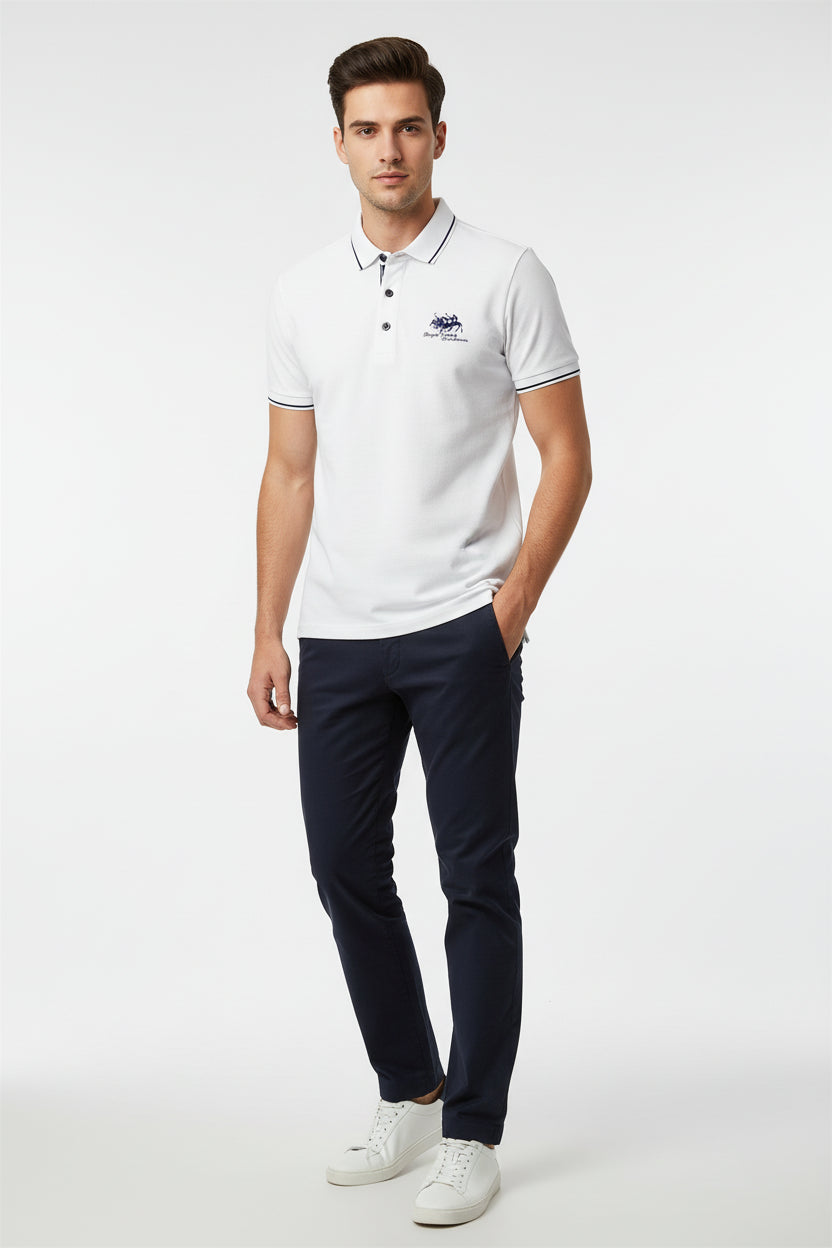 White polo shirt with embroidery on a dark surface