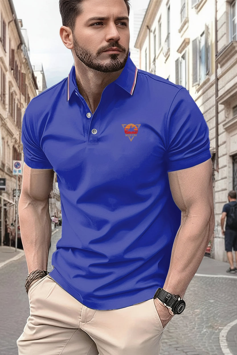 Man wearing a blue polo shirt with a logo on a city street