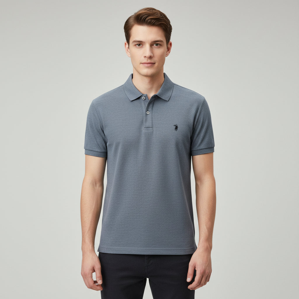 Blue polo shirt with a brand logo held by a hand on a neutral background