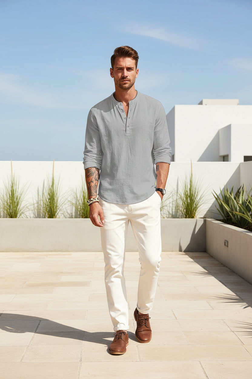 Man wearing a light gray long-sleeve shirt with rolled-up sleeves on a white background