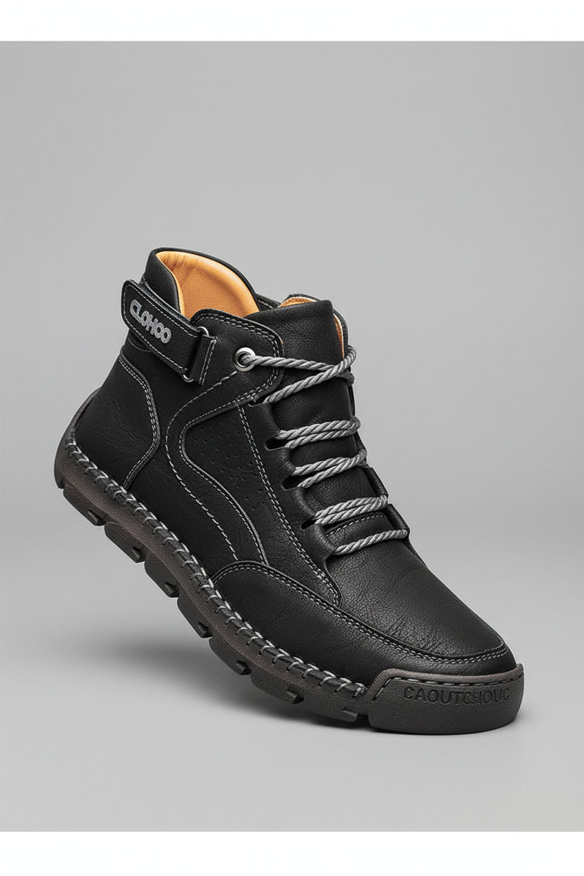 Black leather boot with visible brand name on a beige background