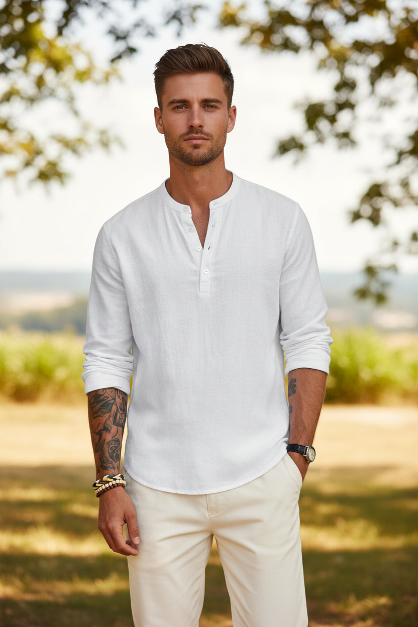 Man wearing a white long-sleeve shirt with rolled-up sleeves on a white background