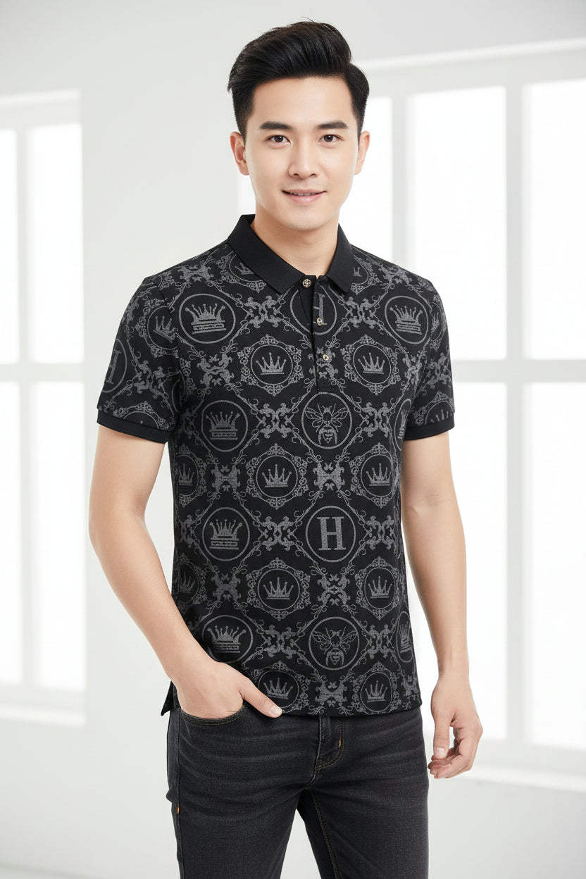 Black polo shirt with white crown and 'H' pattern on a dark surface