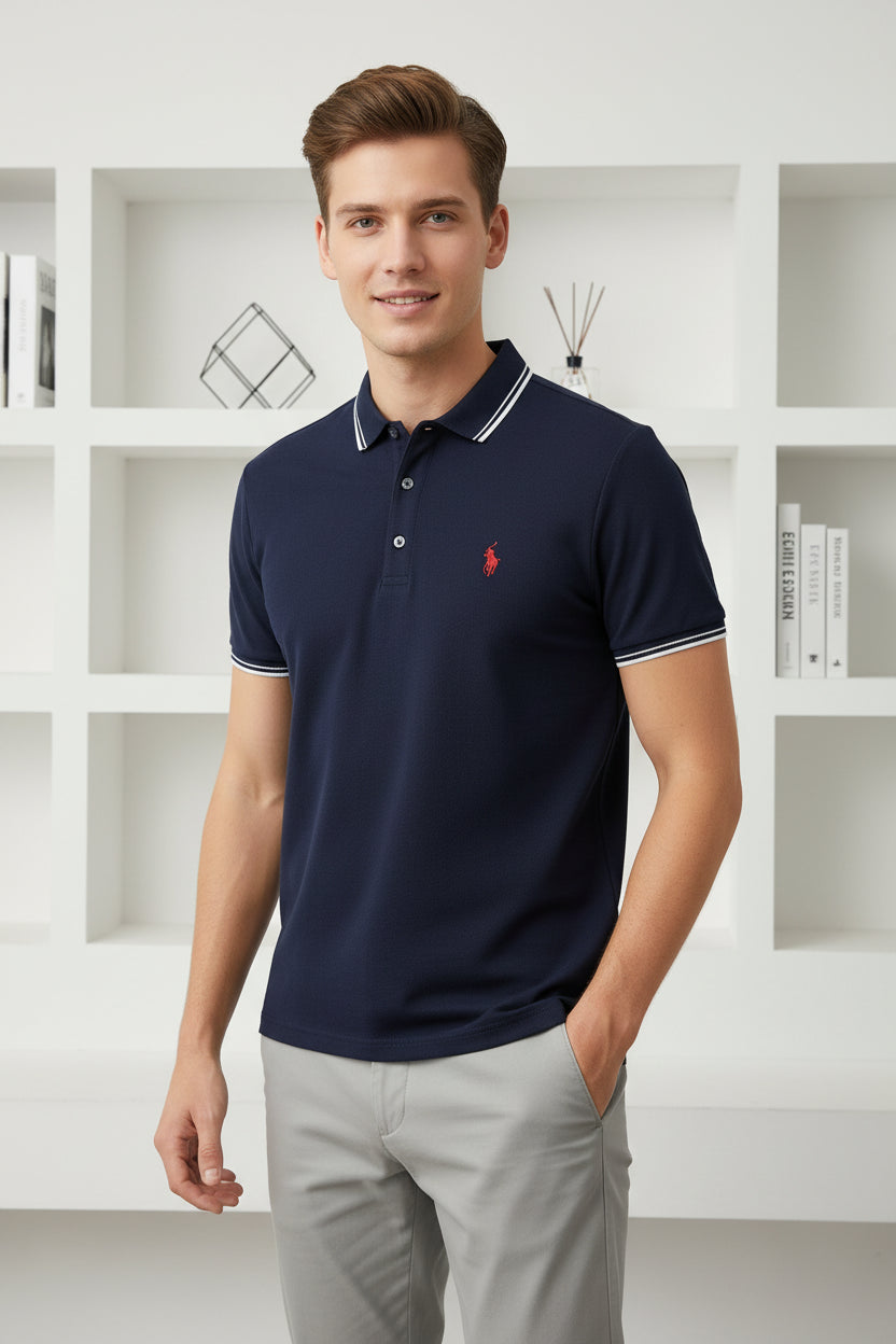 Navy blue polo shirt with a red logo on a rack of other shirts.
