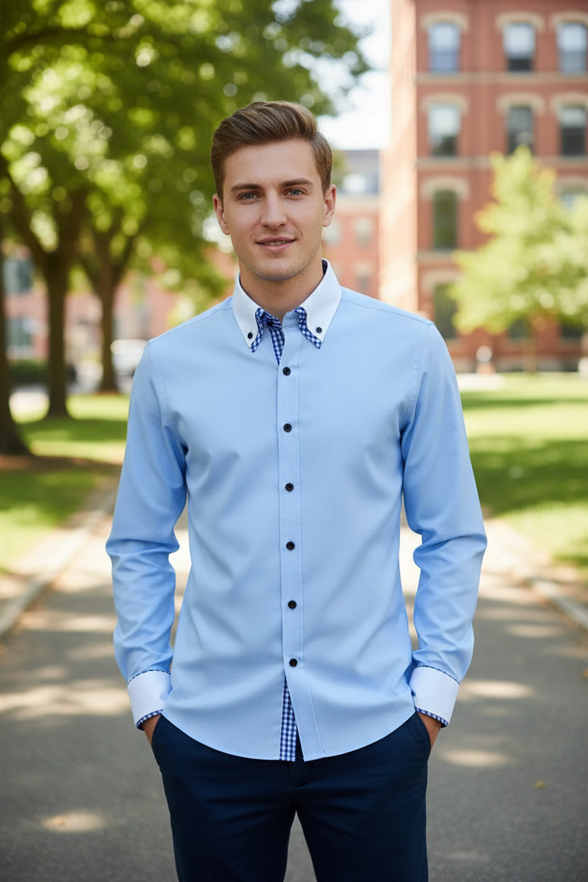 Light blue dress shirt with checkered inner lining on a gray background