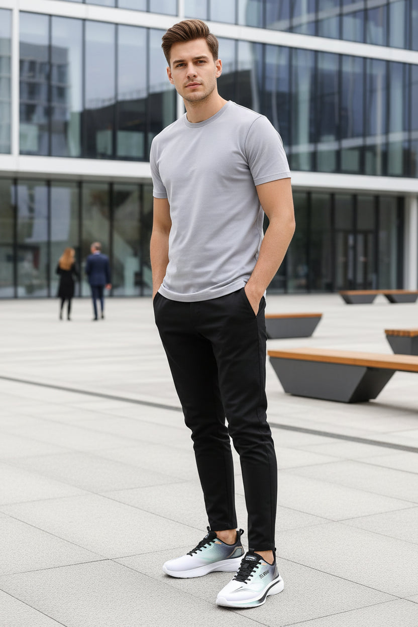 White athletic shoe with black accents on a gray background