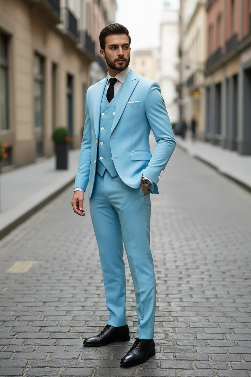 Man wearing a light blue suit with a white shirt and black tie on a city street.