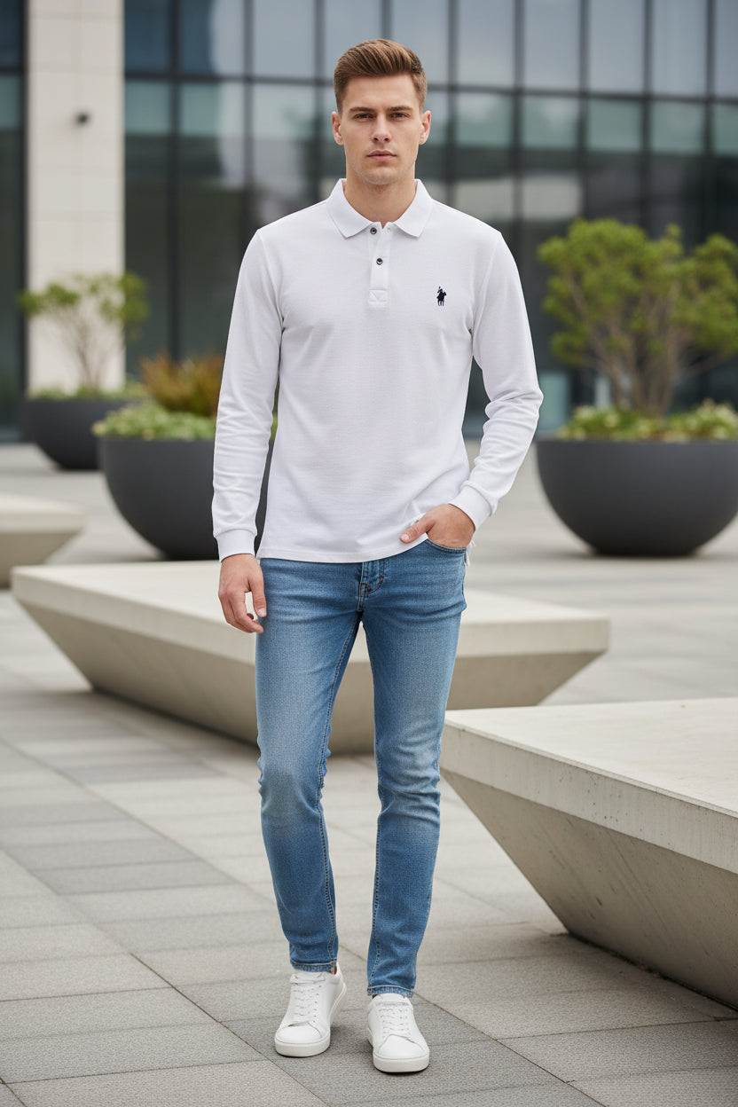 White long-sleeve polo shirt with a brand logo on a hanger against a clothing rack background.