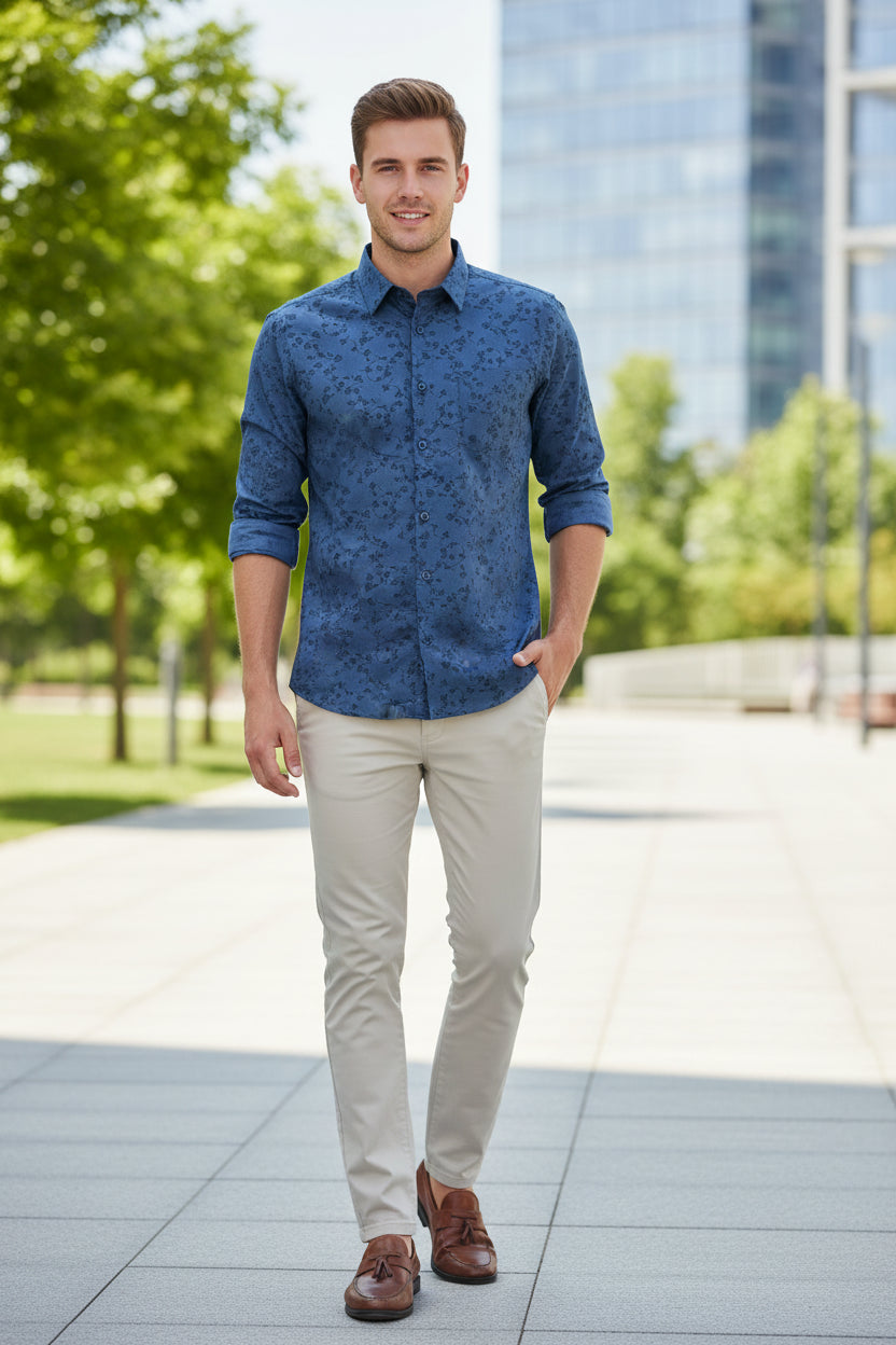Folded blue shirt with floral pattern on a white background