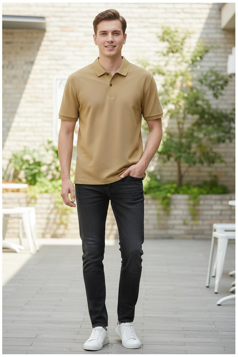 Beige polo shirt on a hanger with a hand touching it, against a blurred indoor background.
