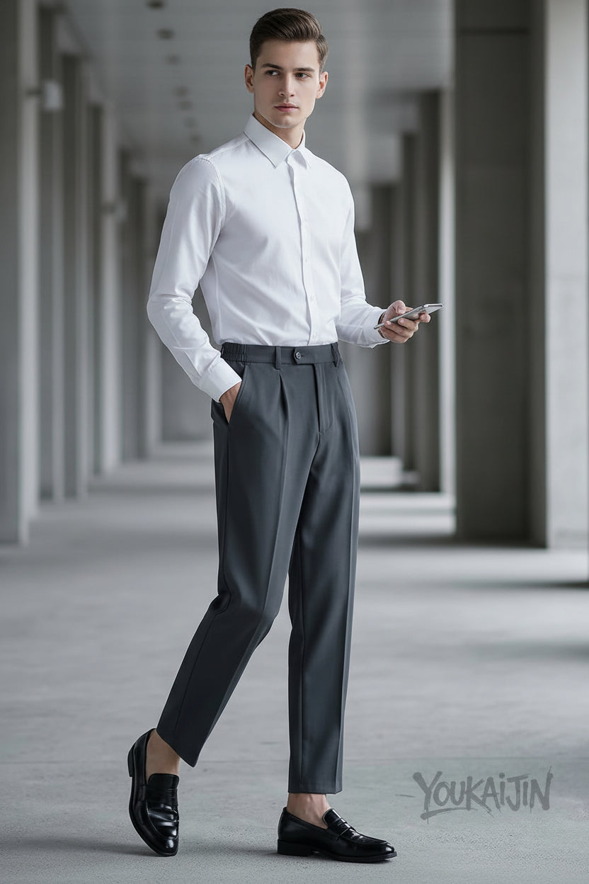 Person wearing gray dress pants and black shoes in an indoor setting