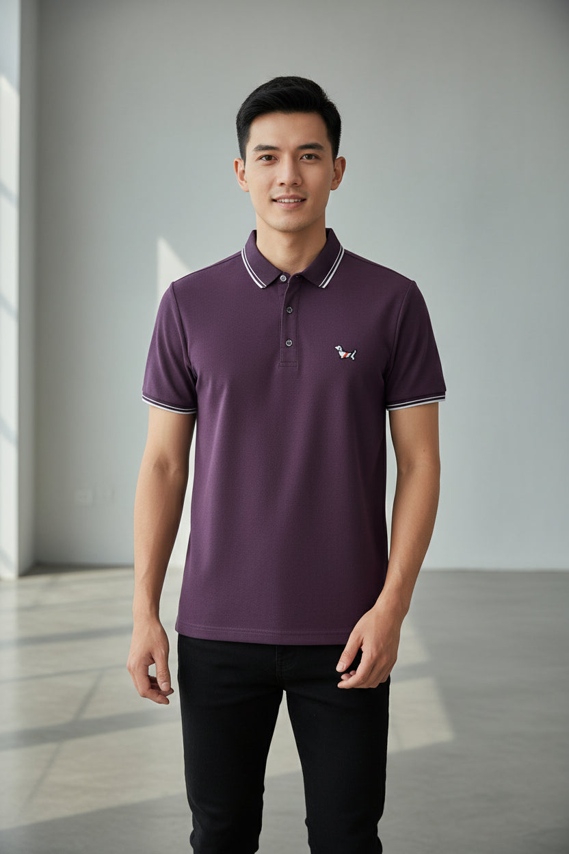 Purple polo shirt with a yellow logo on a rack of clothes