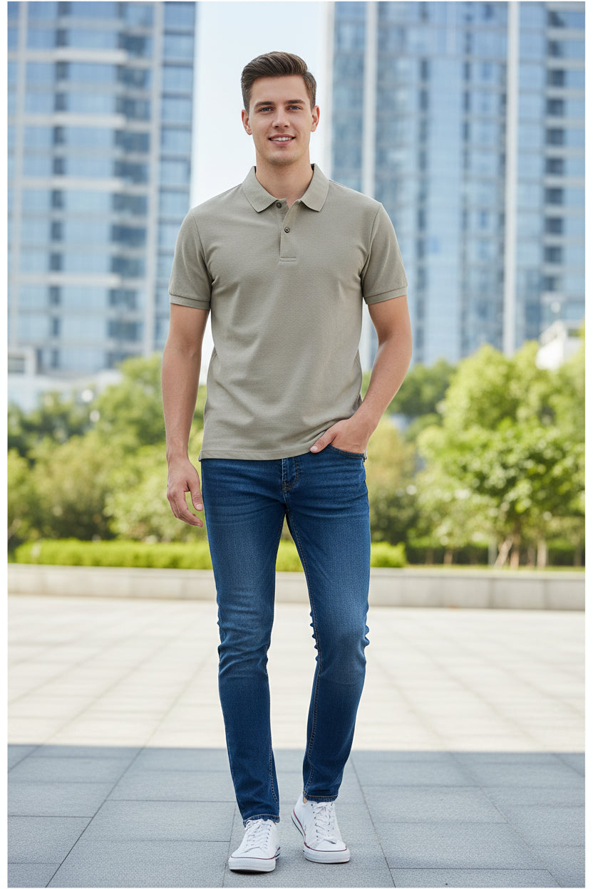 Beige polo shirt held by a hand with other shirts in the background