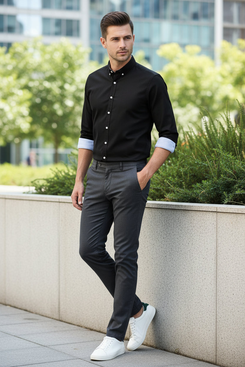 Black dress shirt with white buttons on a white background