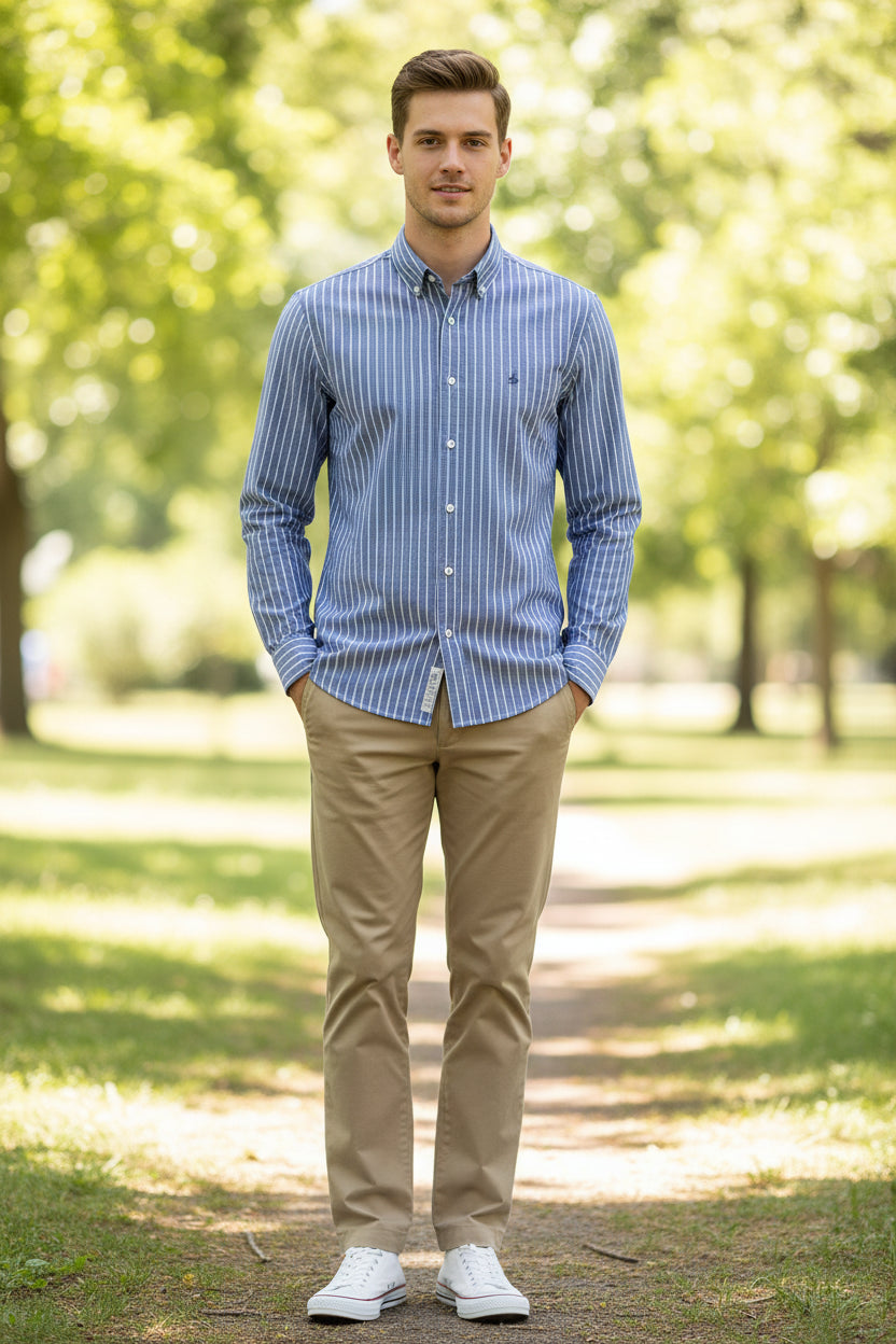 Folded blue and white striped shirt with a brand label on a light gray background