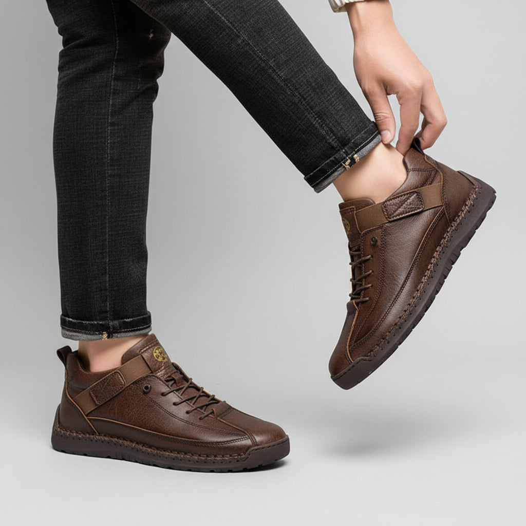 Brown shoes worn with black pants on a beige background